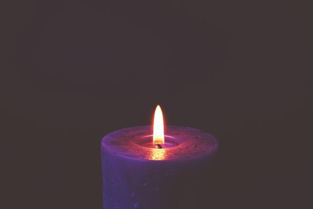 Photograph of candle, dark, fire.