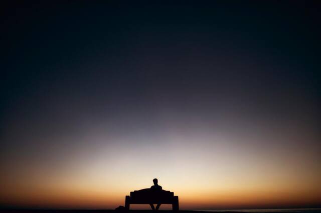 Photograph of alone, bench, dark.