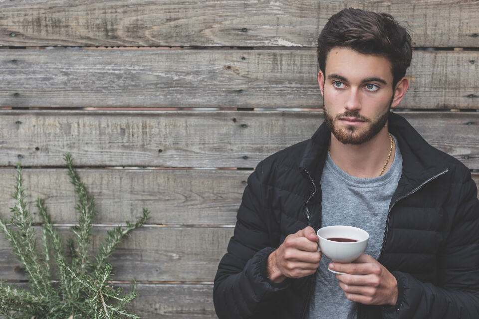 Photograph of beard, coffee, cup.