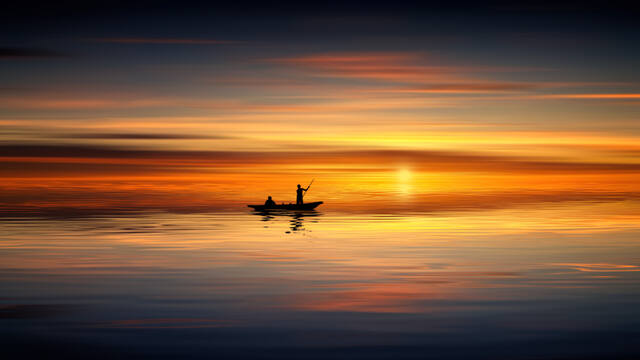 Photograph of boat, bright, calm.