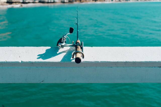 Photograph of fishing, ocean, pier.