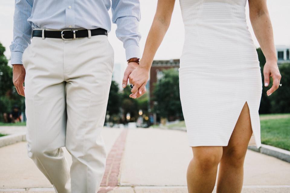 Photograph of couple, formal, holding hands.