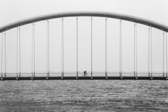 Photograph of architecture, bicycle, biker.