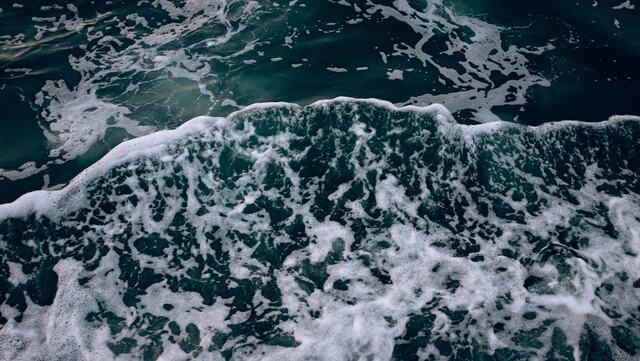 Deep blue water with white foam.
