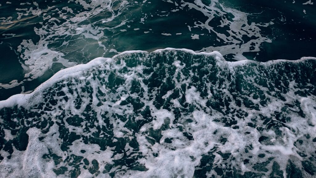 Deep blue water with white foam.