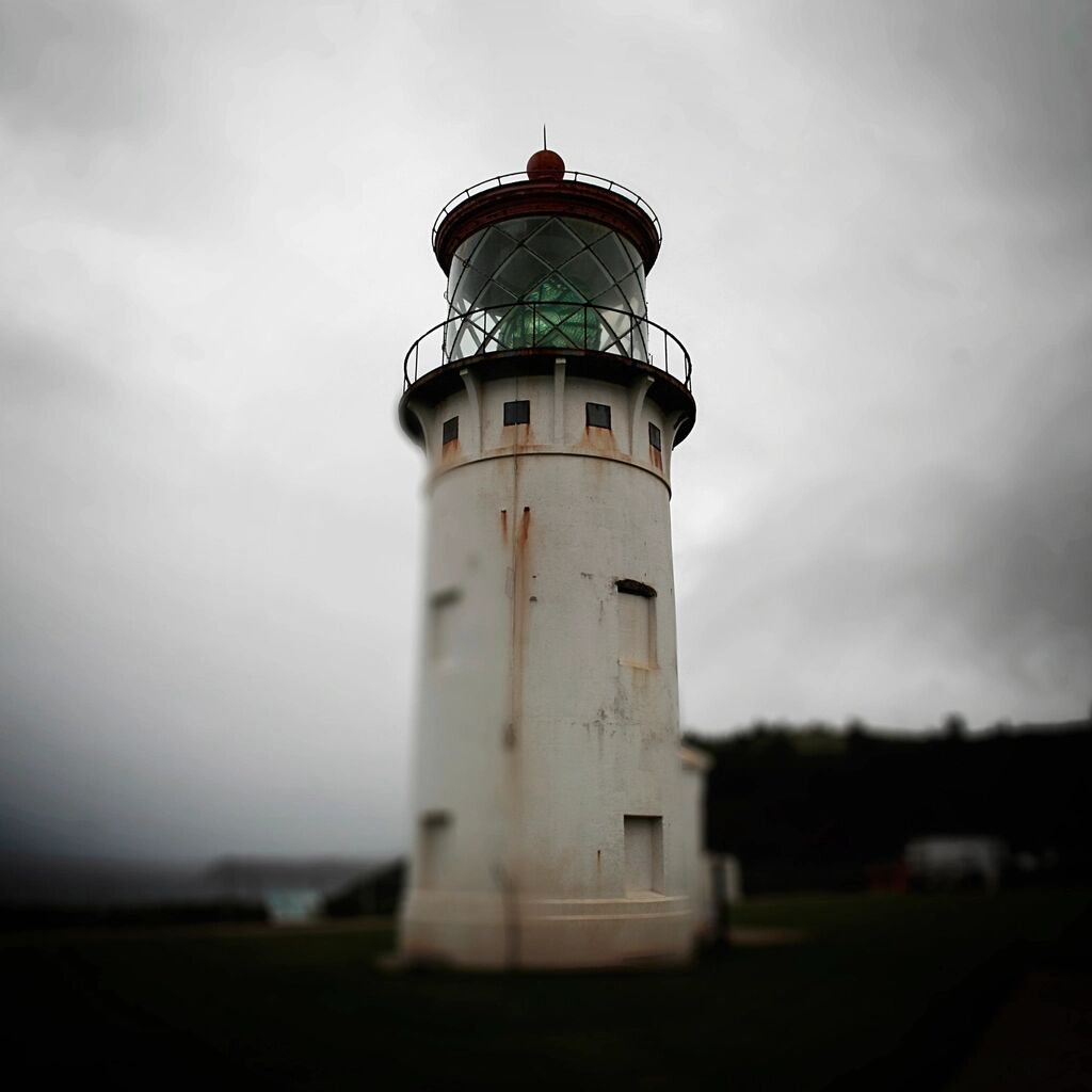 A white lighthouse under a grey sky.