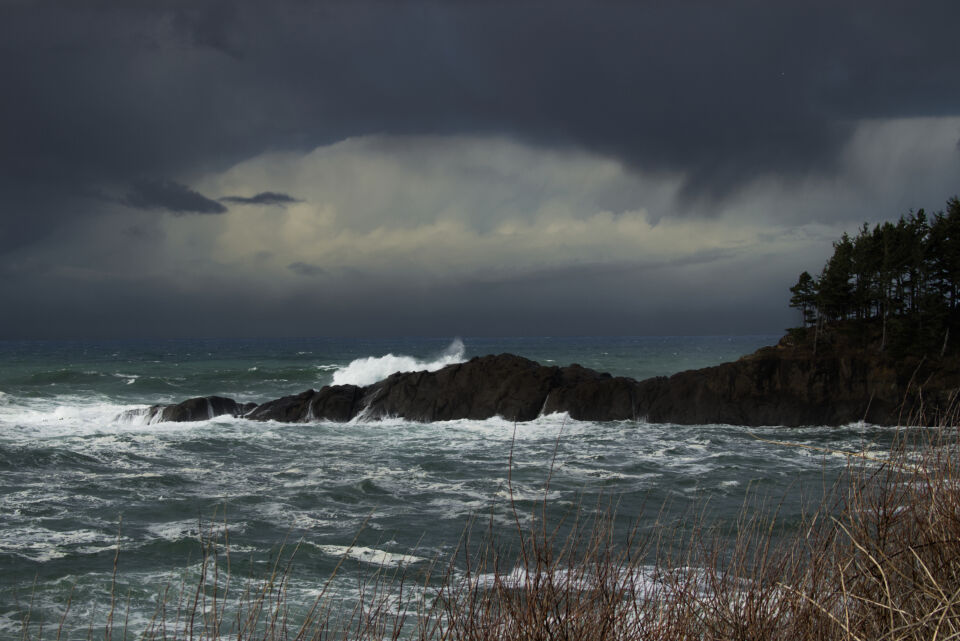 Dark storm clouds over crashing waves.